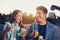 Two cheerful teenagers, girl and boy, eating pizza