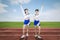 Two cheerleaders cheering at the football field