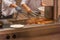 Two chef preparing grilled lobsters on electric stove in kitchen