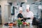 Two chefs discuss the menu in the kitchen of a restaurant or hotel.