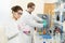 Two chemist researchers workers in laboratory