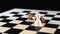 Two chess pawn and king with the vanquished black chess piece lying on its side and the white pawn standing upright