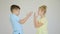 two children are arguing, the girl and the boy are arguing and gesturing with their hands,