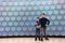 Two children on background of glowing wall panel