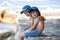 Two children, boy brothers, sitting on a pier on mediterranean s