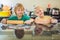 Two children a boy and a girl make cookies from dough