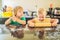 Two children a boy and a girl make cookies from dough