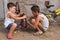 Two children, boys, repairing a bicycle outdoors, holding tools, an active lifestyle