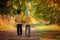 Two children, boys, walking on the edge of a lake on a sunny autumn afternoon