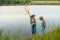 Two children with a butterfly net near the river