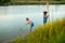 Two children with a butterfly net near the river