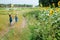 Two children with a butterfly net walk through the countryside