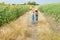 Two children with a butterfly net walk through the countryside