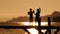 Two Children Dancing On Bridge At Sunset