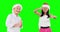 Two children dancing with Santa hat