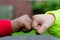 Two children of different races greeting each other with fist bump. Photo shows friendship, support, equality and diversity. One