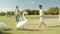 Two children feed the swans in the park, summer, sun, positive, laughing mother