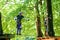 Two children in forest adventure park. Kids boys in helmet climbs on high rope trail. Agility skills and climbing