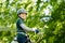 Two children in forest adventure park. Kids boys in helmet climbs on high rope trail. Agility skills and climbing