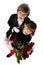 Two children in formal clothing and red roses