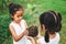 Two children girl holding the young tree for planting together