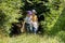 Two children, girls, curious kids exploring the forest together walking through green lush foliage alone, adventure and