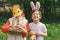 Two children hunt for Easter eggs in a spring garden. Easter tradition