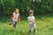 Two children hunt for Easter eggs in a spring garden. Easter tradition