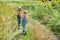 Two children with a insect net catches butterfly