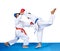 Two children in karategi are training karate blows