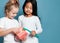 Two children kids friends with toothbrush hold big dental implant model try to brush teeth