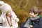 Two Children Leaning Over Wooden Fence Talking