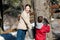 Two children looking in a maple sap bucket