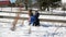 Two Children are Making a Big Snowball Enjoying Warm Sunny Weather Outdoors. Sister and Brother are Playing in Winter