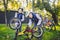 Two children, older boys and younger brother learning repair bike. Two guys siblings in helmets and single clothes use pump tool