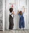 Two children paint indoors