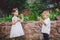 Two children in the park blowing soap bubbles and having fun. Two baby Playing With Soap Bubbles. brother and sister having fun