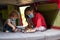 Two children playing chess in a camper van, wearing the protective mask