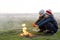 Two children playing with fire outdoors in cold weather