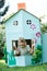 Two Children Playing In Home Made Cardboard House