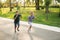 Two children are playing in the park. Two beautiful boys in T-shirts and shorts have fun smiling. They eat ice cream