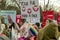 Two children in rabbit masks surrounded by people with Anti Fur placards and posters at Animal Rights Protest