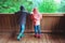 Two children in rubber boots explore nature park and looking for