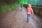 Two children in rubber boots explore nature park and looking for