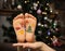 Two children`s bare feet with painted holiday pictures on the New Year theme