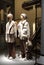 Two children`s mannequins in the window of a clothing store, dressed in a light jacket and fur coat