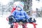 Two children sledding in winter