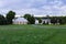 Two-chimney Regency style country cottage with metal chopsticks roof and large barn