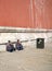 Two Chinese men sit on the floor and smoke