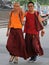 Two chinese monks are walking by streets in Chengdu